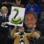 Spurs fan holding Kawhi and snake emoji posters nearly ejected